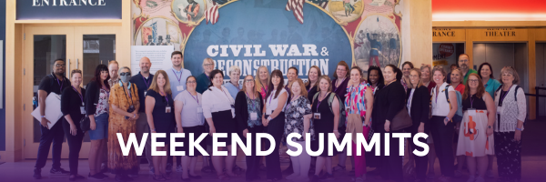 Weekend Summits - A photo of teachers gathered in front of a display
