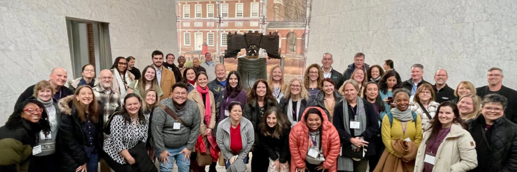 A group of teachers gathered in front of the Liberty Bell
